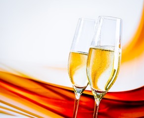a pair of champagne flutes on blur light background