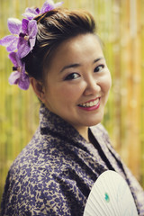 Onsen series : Asian woman in yukata holding paper fan with vintage effect