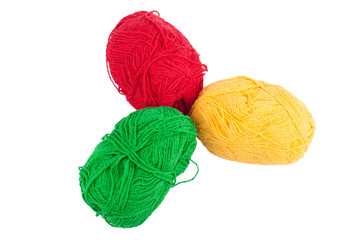 Green yellow red skeins of wool isolated on a white background.