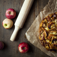 homemade apple pie on parchment paper  on vintage tab