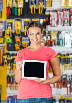 Woman Displaying Digital Tablet In Hardware Shop