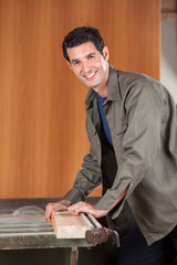 Confident Carpenter Cutting Wood With Tablesaw