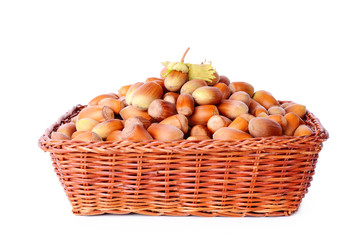Heap hazelnut in basket isolated on white