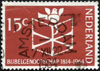 stamp printed in the Netherlands shows Bible, Chrismon and Dove