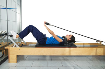young girl performs exercises with pilates gear