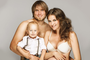 young pregnant couple with son