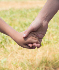 Mother holding a hand of her son