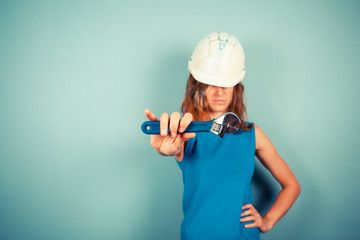 Female builder holding a wrench