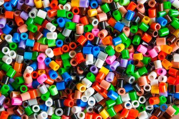 Fototapeta na wymiar multicolored plastic hama beads toy for kids