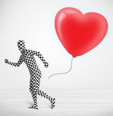 Cute guy in morpsuit body suit looking at a balloon shaped heart