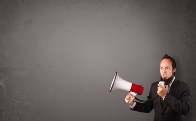 Guy shouting into megaphone on copy space background