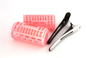 Pink hair curlers with hairpin isolated on white background