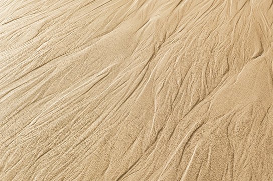 Traces of flowing water on the sand