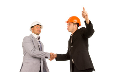 Two Young Angry Male Engineers Shaking Hands