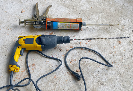 Construction Site: power drill with pistol cartridge resin.