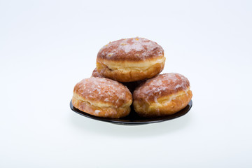 whole donuts on the black porcelain plate