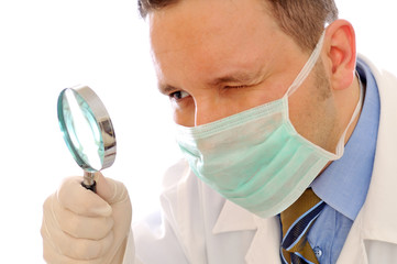 Doctor is looking at magnifying glass