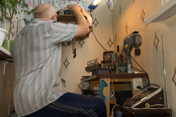Senior man working at a workbench