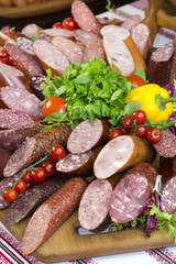 sausages on a wooden plate with vegetables in a restaurant