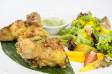 chicken in curry with salad and sauce