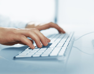 hands pushing keys of computer