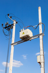 Transformer on high power station against blue sky background