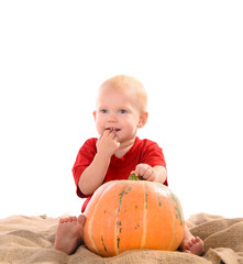 child with orange pumpkin