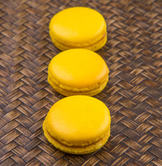 Yellow colored French macarons on wicker background