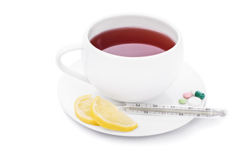 Tea with lemon, some pills and thermometer