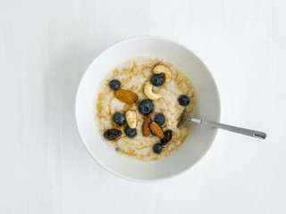 Oatmeal porridge with fresh blueberry, honey and nuts