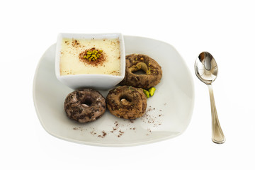 white chocolate dessert with pistachio and biscuits