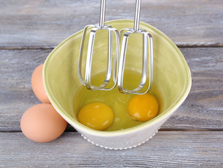 Cooking: whipping eggs with electric mixer in bowl