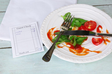 Check and remnants of salad on table close-up