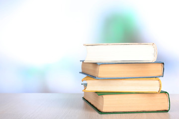 Books on wooden table on natural background