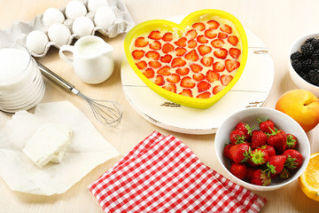 Baking tasty pie and ingredients for it on table in kitchen