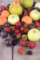 Ripe fruits and berries on wooden background