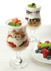 Natural yogurt with fresh berries on wooden table