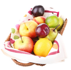 Assortment of juicy fruits in wicker basket, isolated on white