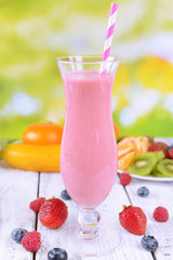Delicious berry cocktail on table on bright background