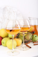 still life with apple cider and fresh apples on wooden table