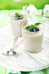 Delicious berry mousse in glasses on table close-up