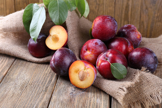 Sweet plums on wooden background