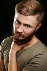 Portrait of handsome man with beard on black background