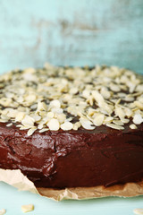 Tasty chocolate cake with almond, on old wooden table