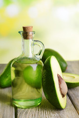 Avocado oil on table on light background