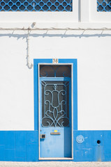 Old building. White facade and blue door
