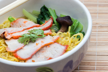 Chinese egg noodles with red pork in hot soup