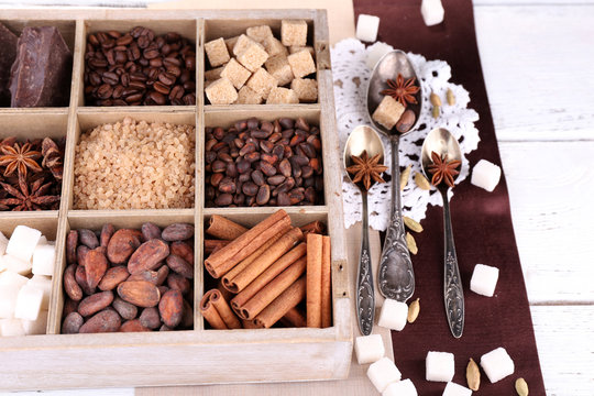 Wooden box with set of coffee and cocoa beans, sugar cubes,