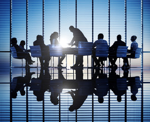 Silhouettes Of People In A Conference Room