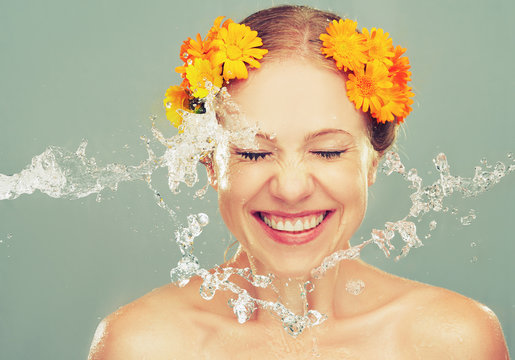 Beauty Laughing Girl With Splashes Of Water And Yellow Flowers